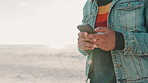 Beach, phone and closeup of man typing a text message or email on the internet or website. Technology, travel and male person networking on social media or mobile app with cellphone by ocean or sea.