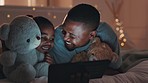 Bed, night and girl with father, tablet and happiness with cartoon, home and relax with connection. Black family, parent and dad with daughter, child and kid with technology, teddy bear and internet