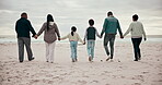 Big family, holding hands and beach walking happy on cloudy day for connection, grandparents or children love. Mother, father and relax holiday time or bonding at ocean, sea waves for support care