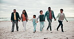 Big family, playing or happy on beach with walking, love and bonding on vacation, holiday or adventure by ocean. Interracial, parents or kids and grandparents at sea with holding hands for experience