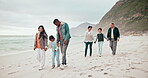 Big family, happy and beach with walking, holding hands and love or bonding on vacation, holiday or adventure. Interracial, parents and kids with grandparents at sea for relationship, care and smile