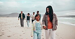 Mother, child and holding hands on beach big family holiday, relax vacation or sea love. Grandparents, father or son talk in sand conversation for senior travel or together trip, cloudy sky at ocean