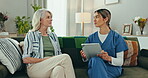 Senior, woman and nurse with tablet for consulting, communication and discussion for healthcare on sofa. Elderly, person and caregiver with touchscreen for conversation for health, report or analysis