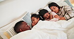 Family, sleeping and parents with children in bed from above with peace in morning and relax together. Mother, father and kids resting in the bedroom of home on a weekend, vacation or holiday