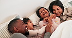 Funny, family and children in bedroom, tickle and play, bonding and happy together in the morning in home. Laughing kids, mother and father in bed, smile and care of interracial parents in top view