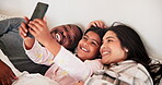 Family, selfie or smile on bed in bedroom of home for bonding, care and relaxing with love or joy. Interracial, parents or girl child with photo memory, happiness or peace with resting in the morning