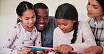 Parents, kids and reading books in bedroom for learning, language development and knowledge at home. Mom, dad and happy girl children relax for bedtime, storytelling and care with interracial family 