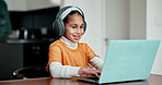 Homework, online learning and child on laptop in home for education, elearning and lesson. School, family and girl with headphones on computer for studying, project and or development in living room