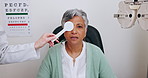 Eye care, reading test and woman in office with occluder, doctor and health insurance in clinic. Advice, eyesight consultation and mature patient in exam to check eyes for glasses, lens and vision.