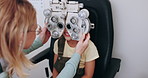 Eye exam, optometry and optician with child on phoropter for testing vision, sight and machine for eyes. Healthcare, medical equipment and young patient with woman for ophthalmology scan in clinic