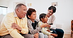 Family, children and grandparents watching tv together on the sofa in a living room of their home for visit. Portrait of a senior man and women with kids for a movie, entertainment and remote control