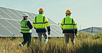 Team at solar panel farm for inspection, clean energy and outdoor electricity maintenance from back. Sustainability, photovoltaic power grid system and technician with engineer to check development.