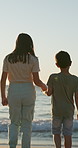 Back, beach or holding hands with a boy and girl on the sand by the ocean at sunset together. Family, love or vacation with a brother and sister sibling outdoor on the coast for summer holiday