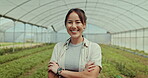 Happy, face and woman in greenhouse for agriculture, ecology or sustainability of plants in nature. Portrait, asian farmer and arms crossed in field for food production, gardening or agro environment