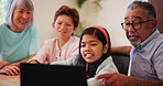 Grandparents, children and laptop watching talk for streaming movie, entertainment or research. Senior couple, boy and girl diversity at table or holiday discussion for learn smile, relax on vacation