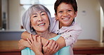 Face, smile and child hug grandma in home, care and trust, bonding and together. Portrait, happy kid embrace grandmother and support, family connection and interracial love of senior woman with boy