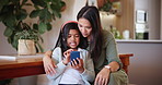 Mother, child and cellphone talking for smile in home for
online entertainment, learning or movie streaming. Indian girl, woman and video watching or scroll information for social media, bond or app