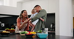 Baby, funny and a couple cooking in the kitchen of their home together for health, diet or nutrition. Love, smile or laughing with a mom, dad and infant child using ingredients for supper or a meal