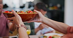 Food, hands and salad for lunch in dining room for celebration, party or event at modern home. Diet, bowl and closeup of person at a healthy vegetarian family meal for dinner or supper in house.