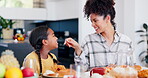 Woman, child and laughing at dinner table, play and funny joke or humor, comedy and eating together. Happy mother and daughter, nutrition and food for lunch, healthy meal and fun or love for wellness