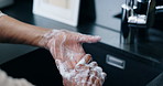 Skincare, soap and person washing hands in kitchen for safety from germs, dirt and bacteria. Cleaning, hygiene and protection, scrub with foam and rinse fingers germs with natural skin care in home.