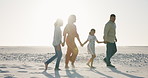 Parents, kids and holding hands for walking on beach for conversation, freedom or relax for holiday. Father, mother and daughter children for care, bonding or love by sea in summer sunshine in Mexico
