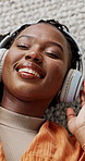 Music, headphones and happy black woman in top view on floor in home, listening to audio or sound to relax. Smile, radio and above of person on carpet streaming song, enjoy technology and eyes closed