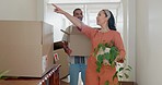 Couple, moving and pointing in new house with boxes. plants and happy with thinking, chat and planning. Man, woman and excited for fresh start, package and investment in property, real estate or home
