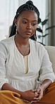 Stress, anxiety and black woman in home thinking with worry for mental health on living room sofa. Sad, doubt and girl on couch with fear, depression or confused with mistake or financial crisis