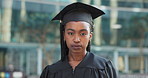 Graduate, education and face of black woman in city for degree, achievement and academic success. University, college and portrait of student with pride for future, career and graduation in town