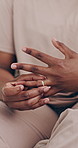Person, hands and ring in divorce, cheating affair or toxic relationship in jewelry removal at home. Closeup of bad marriage, fight or conflict for breakup, doubt or stress in anxiety or mistake