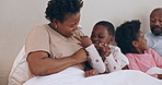 Happy, tickling and black family having fun in bed together at modern home for bonding. Smile, love and African mother and father playing, laughing and being crazy with kids in the bedroom of house.