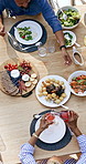Family, lunch and garden with top view of table with juice, plate and vegetables with conversation on patio. Black people, meat and bread with glass, drink and plate for food, summer and backyard