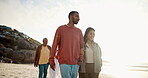 Family, walking and beach with smile, sunset and flare in shore, happy and sand. Relationship, vacation and enjoy for getaway, men and women for marriage, summer and holding hands for love and care