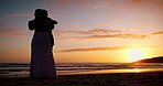 Dancer couple, silhouette and beach with love, sunset sky and freedom with moving together, summer and vacation. Man, woman and dancing outdoor with steps, hug or romance in dusk sunshine by ocean