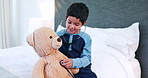 Boy child, stethoscope and play with teddy bear, listening and smile for healthcare, wellness or clinic games. Kid, doctor and happy with toys, consultation and assessment in bedroom in family home