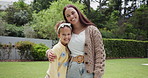 Family, love and a girl hugging her mother in the garden of their home for summer bonding together. Portrait, smile or happy with a woman parent embracing her daughter in the backyard for affection