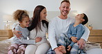 Home, children and mother and father in bedroom for love, bonding and loving relationship. Family, parents and portrait of mom, dad and young kids for playful, care and relax for childhood fun on bed