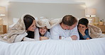 Love, blanket and family in a bed happy, bond and playing in their home with support and comfort. Security, trust and children in a bedroom with mom, dad and funny games in house with weekend freedom