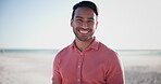 Summer, holiday and face of happy man on beach, vacation and freedom to relax in nature. Person, smile and portrait with wellness at sea or ocean in Brazil sunshine, outdoor on sand and blue sky