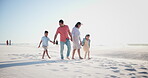 Family, parents and kids on beach with holding hands for walking, relax and bonding on holiday. Travel, man and woman with children by ocean or sea for vacation, adventure or experience with talking