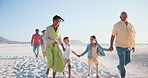 Big family, grandparents and parents with children on beach for walking, holding hands and relax on holiday. Travel, men and women with kids by ocean or sea for vacation, adventure or experience