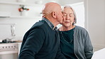 Senior couple kiss with paperwork for budget, pension portfolio and financial assets at home. Happy old man, woman and reading banking documents for retirement savings, insurance policy or investment