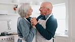 Senior couple, dancing and kitchen with cooking, smile and love in a home with retirement and marriage. Support, music and elderly people together with bonding, date and happy in a house with care 