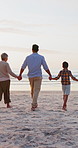 Back of big family, walking or holding hands on beach with love or nature to relax on holiday. Generations, parents or grandparents with kids for care or vacation travel by coast for peace wellness