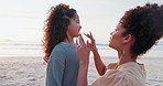 Beach, sunscreen and application by mother and daughter at the ocean for summer, vacation or fun. Face, spf and mom with girl child at the sea for skincare, protection or facial cream in nature