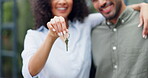 Hands, couple and keys outdoor of new home, real estate and building investment in neighborhood. Closeup, happy man and woman celebrate finance with key for moving to house, property or mortgage loan