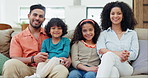 Happy, smile and face of parents and children on a sofa for bonding and relaxing together at home. Care, love and portrait of young Indian mother and father with kids in living room of modern home.