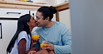 Couple, cheers and kiss in kitchen with happiness, conversation and bonding on floor with juice in home. Love, man and woman with beverage, talking or communication for romance and care in house