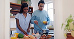 Love, cooking and couple in the kitchen with recipe on internet for breakfast on weekend morning. Love, conversation and young man and woman preparing healthy meal for lunch in apartment with love.